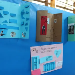 blaue Wand mit vier Plakaten 