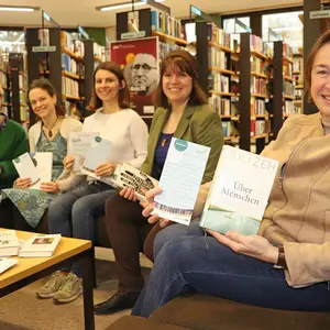 Fünf Frauen sitzen auf einem Sofa und halten ihre Buchempfehlungen in die Kamera.