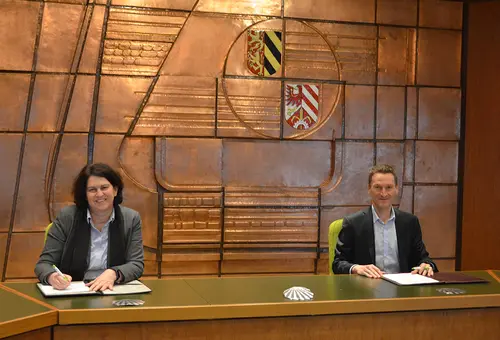 Erste Bürgermeisterin Birgit Huber und der Geschäftsführer der Stadtwerke Zirndorf, Andreas Neusinger unterzeichnen den Vertrag im Sitzungssaal des Rathauses