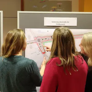 Drei Frauen vor einer Infotafel