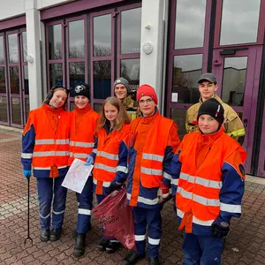 Jungs und Mädchen der Jugendfeuerwehr vor der Fahrzeughalle.