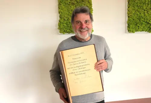 Norbert Schikora zeigt das Goldene Buch mit Eintrag vom 10. November 1993. 