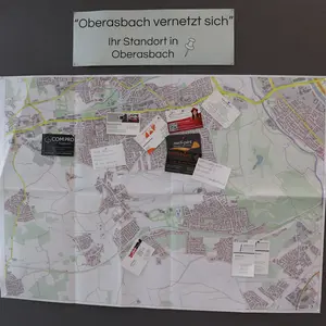 Ein Stadtplan auf einer Pinwand, an dem mit Nadeln die Visitenkarten der Unternehmen sichtbar gemacht wurden. 